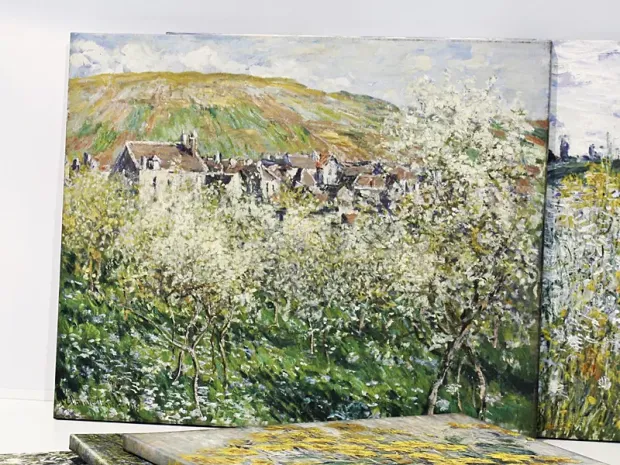 Reproduction of Claude Monet\'s Flowering Plum Trees, adding a subtle charm of Impressionism to modern decor.