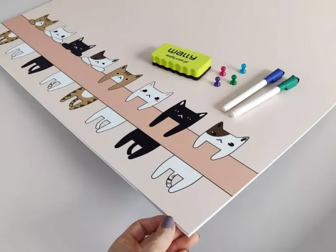 Dry-erase magnetic board for kids featuring various cat illustrations.