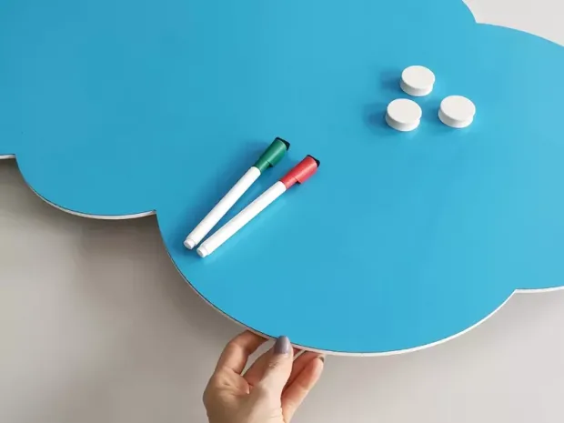 Blue cloud-shaped dry-erase magnetic board with markers, featuring a graphic design.