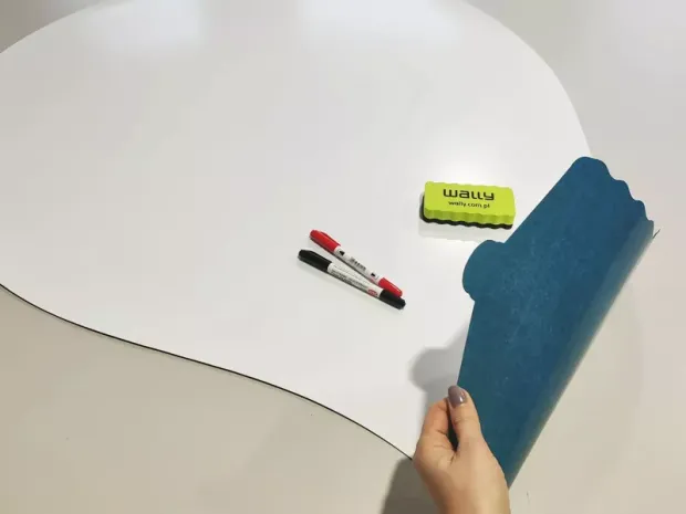 Dry-erase magnetic board in light bulb shape with rounded edges, featuring a graphic design.
