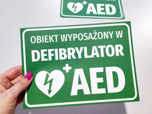 AED Defibrillator Equipped Sticker - Graphic Design. Green background with white text and heart symbol.
