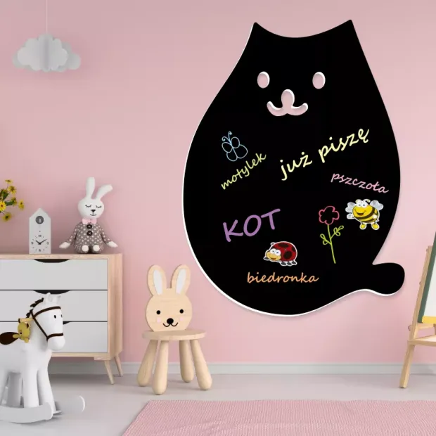 Chalkboard magnetic board for kids featuring a cat design, perfect for a child\'s room with light pink walls.
