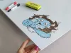 Dry-erase magnetic board for kids featuring a blue monster design.
