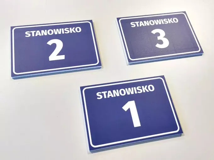 Position plaque with number and letter - Graphic design. Simple rectangular plaques with white text on blue background.