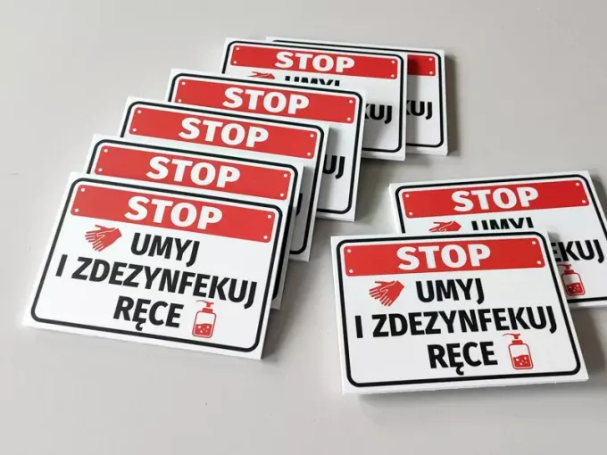 Wash and disinfect hands sign - Graphic design. Rectangular sign with red text on a white background.
