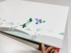 Magnetic dry-erase board for kids featuring animals and mountains, with animals visible at the bottom.
