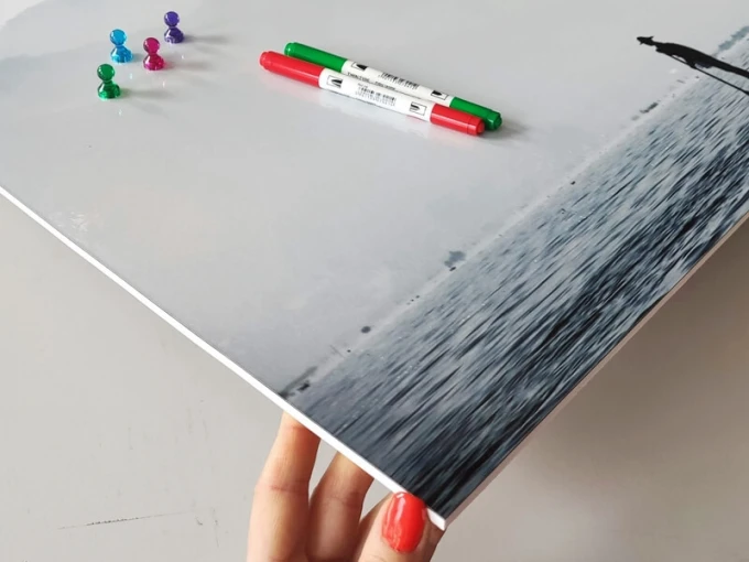 Magnetic whiteboard fisherman 253 - Graphic design featuring a fisherman against a water backdrop in shades of gray.