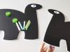 Chalkboard magnetic board for kids featuring dinosaurs - two rectangular dinosaurs with big eyes.