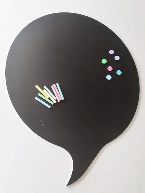 Chalkboard magnetic board in speech bubble shape with chalk and colorful magnets.