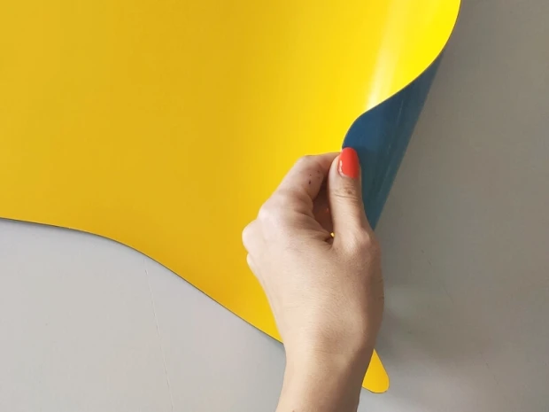 Dry-erase magnetic board Dymek 048 - Graphic design. Yellow surface with blue rounded corner at the bottom.