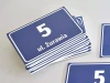 Address plaque with street and house number - Rectangular design featuring a large white number and text on blue background.