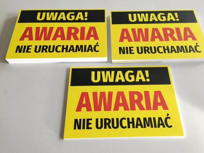 Caution: Do not operate - Graphic design with yellow background and large red letters on a black strip.