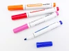 Set of 8 colorful dry-erase markers with round tips and graphic design.