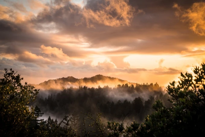 Wall mural of colorful clouds over mountains FP 6457 - Graphic design. Clouds in shades of orange and gray.