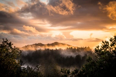 Wall mural of colorful clouds over mountains FP 6457 - Graphic design. Clouds in shades of orange and gray.