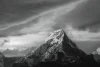 Wall mural of snow-capped mountain peaks FP 6466 - Graphic design. Mountain with a white summit against dark clouds.