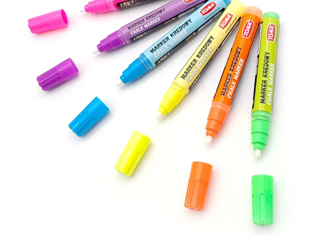 Toma TO-292 chalk markers in various colors - Graphic design. Colorful markers on a white background with visible tips.