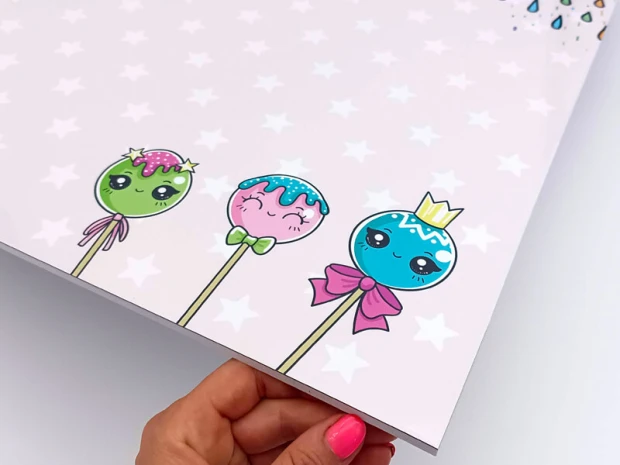 Magnetic dry-erase board for kids featuring a unicorn design with three colorful lollipops and smiling faces.