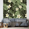 Tropical Leaves Wallpaper 0117 - Living room decor with dark walls, green leaves, and white flowers.