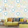 Colorful Geometric Wallpaper 0203 - Living room decor with light walls and yellow and blue furniture.
