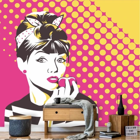 Pop-art wallpaper featuring a woman with a bun holding a pink fruit, set against a polka dot background.