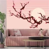 Peach flower branch wallpaper on a sunlit background - Living room decor with pink walls and light furniture.