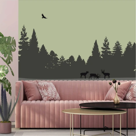 Deer wallpaper in a dense forest, styled in a green living room with pink furniture.