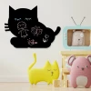 Chalkboard magnetic board for kids featuring a cat, perfect for a bright children\'s room with colorful walls and furniture.