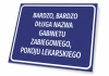 Office nameplate for medical rooms, featuring a graphic design. Simple rectangular plaque with white text.