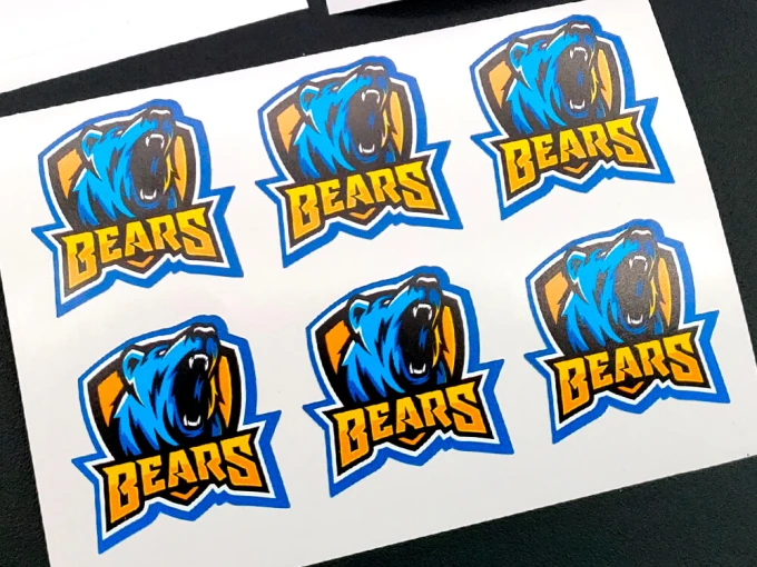 Self-adhesive labels in any shape on a sheet - Graphic design. Six labels featuring a bear image and text.