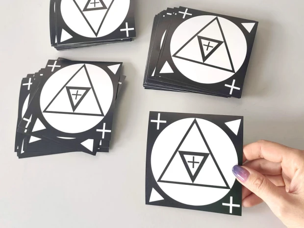 Custom adhesive stickers - Graphic design with triangles and circles in contrasting colors.