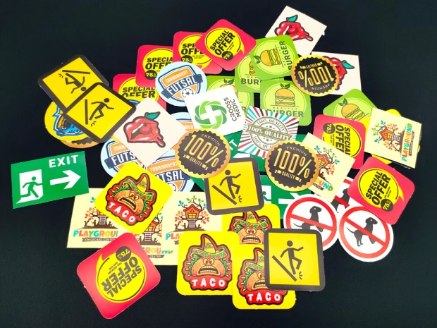 Custom printed adhesive stickers - graphic design. Includes various shapes, such as round and rectangular.