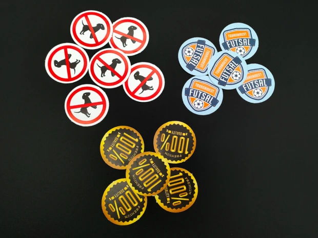 Custom printed adhesive stickers - Graphic design. Includes round stickers with symbols and text.