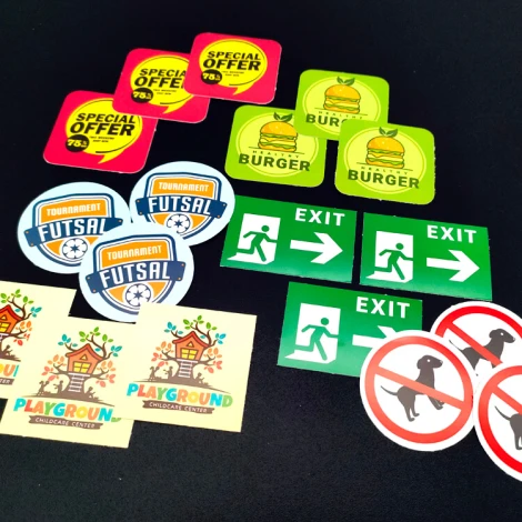 Custom printed adhesive stickers - graphic design. Includes text, symbols, and various shapes.