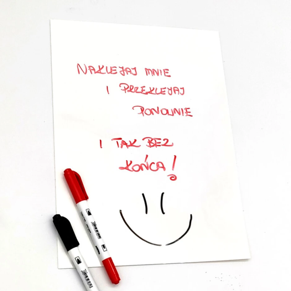 Self-adhesive A4 dry-erase film with a graphic design. Red text on a white background. Reusable application.
