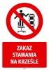 Safety sticker: No standing on chairs - graphic design. Red circle with crossed-out figure on a chair.