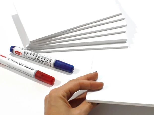 A4 whiteboard with graphic design, featuring rectangular sheets and red and blue markers.
