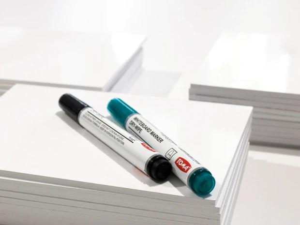 A4 whiteboard with graphic design. Includes two markers: one black and one turquoise.