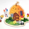 Magnetic dry-erase board shaped like a beehive with a graphic design of a bee house.