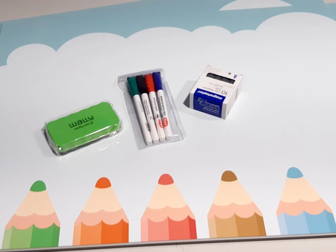 Magnetic whiteboard for kids with colorful pencil design on a white background.