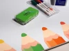 Magnetic dry-erase board for kids with a graphic design featuring colorful pencils on a white background.