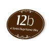 Address plaque, house number - Graphic design. Oval shape, brown background, white numbers and text.