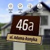 Address plaque with house number 46a and the text ul. Adama Asynka in a rectangular design.