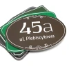 Address plaque with house number - Graphic design. Oval shape, brown background with white text and decorative elements.