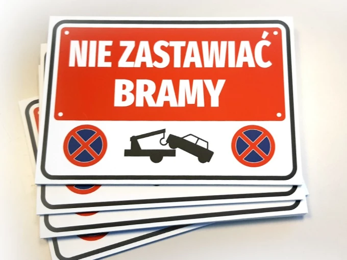 No Parking Sign - Graphic Design. Red background with white text, towing symbol, and prohibition signs.