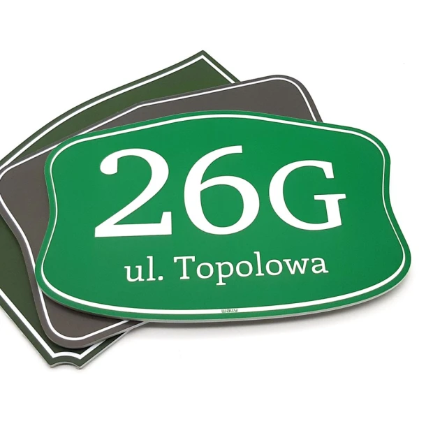 Green address plaque with white lettering and rounded edges.