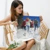 Photo poster 40x50 cm - Bright room setting. Person holding a poster of a group of people in the snow.