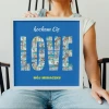 Photo collage gift in the form of a 50x50 cm design. LOVE text filled with photos on a blue background.
