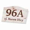 House number plaque with graphic design. Rectangular sign featuring number 96A and street name on the background.