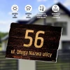 House plaque with address and property number - Graphic design. Simple style with large numbers on a wood-like background.